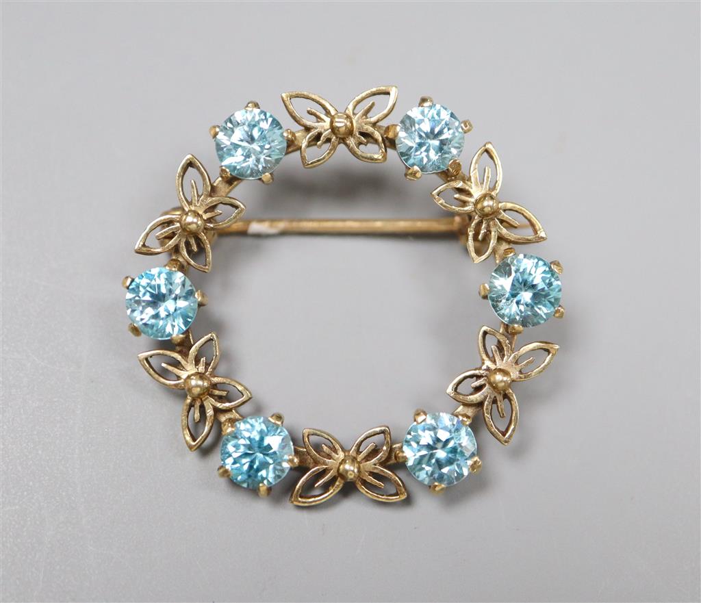 A modern 9ct gold and blue zircon set openwork circular brooch, 30mm,